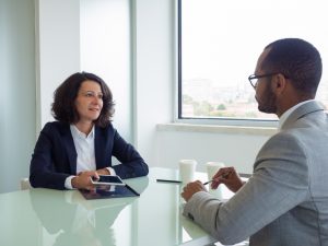 professional sitting at a desk with a client